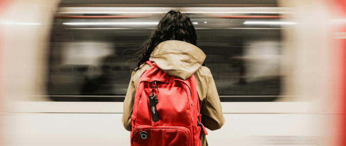 The Backpacker’s Pause Beneath the Clinking Market Awnings